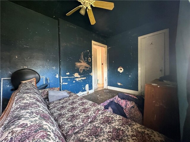 bedroom featuring a ceiling fan and baseboards