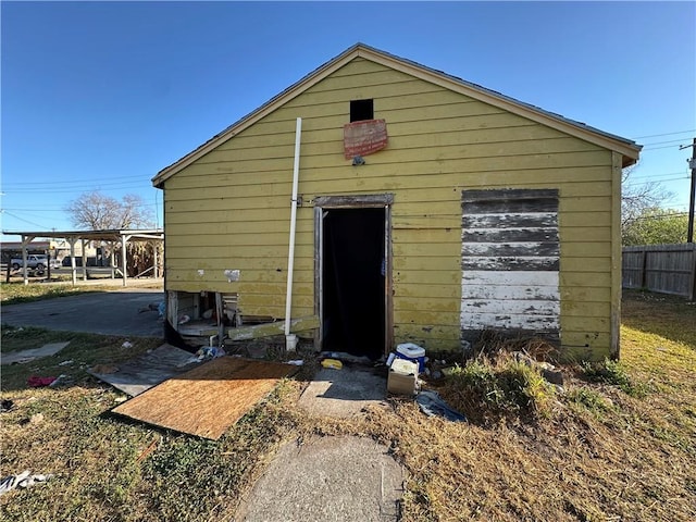 view of outdoor structure featuring an outbuilding and fence