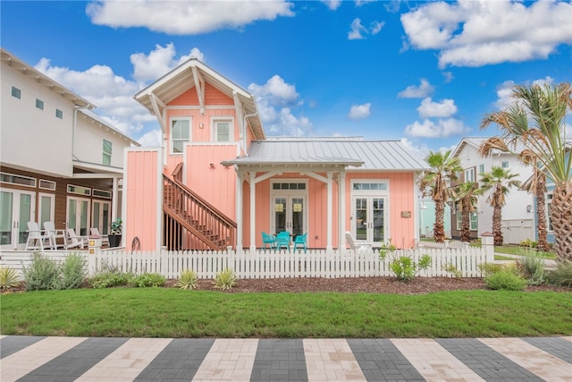 back of house featuring a yard and french doors