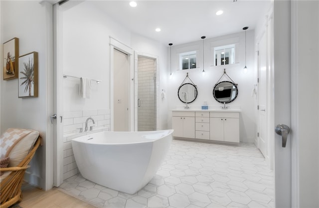 bathroom featuring vanity and plus walk in shower