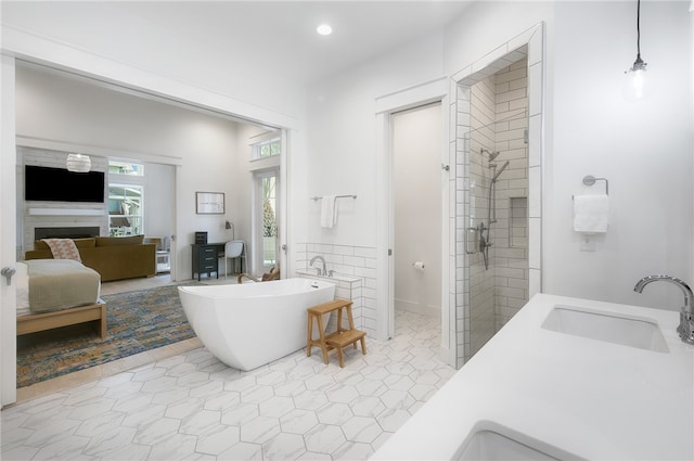 bathroom with tile patterned flooring, sink, and separate shower and tub