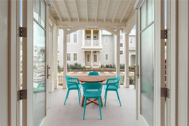 sunroom / solarium with french doors, a healthy amount of sunlight, and beam ceiling