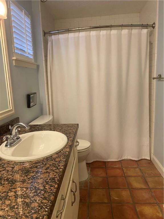 104 Park Pl, Portland, TX 78374 - full bath featuring vanity, tile patterned floors, and a shower with shower curtain