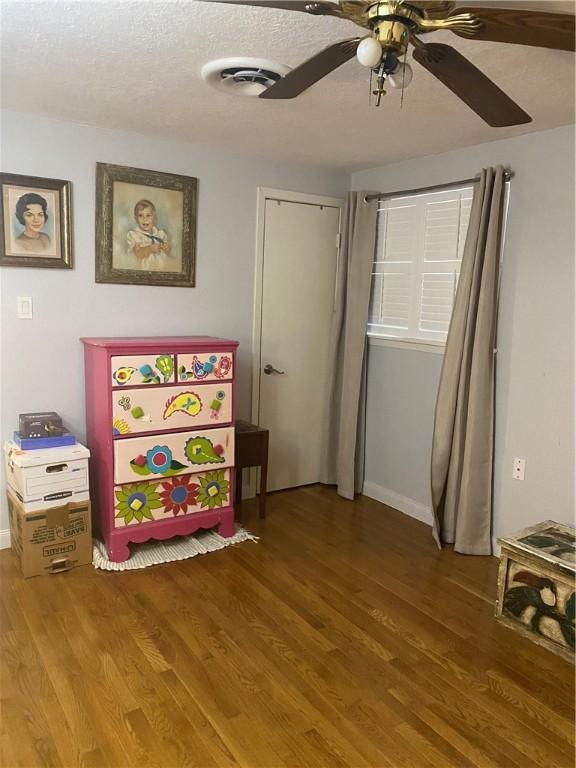 104 Park Pl, Portland, TX 78374 - bedroom with wood finished floors, a ceiling fan, and a textured ceiling