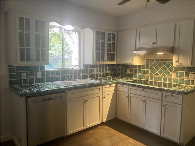 104 Park Pl, Portland, TX 78374 - kitchen featuring stainless steel dishwasher, tile countertops, under cabinet range hood, and white cabinetry