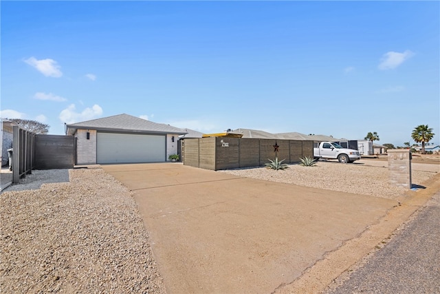 view of front of house with concrete driveway, roof with shingles, and fence