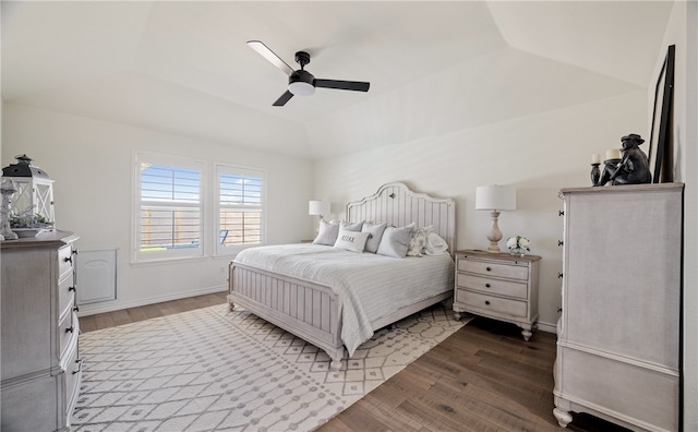 bedroom with lofted ceiling, ceiling fan, baseboards, and wood finished floors