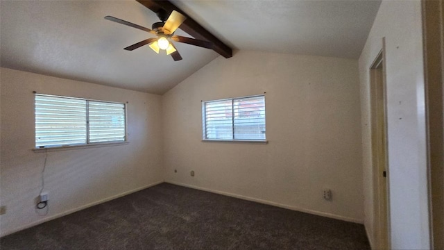 carpeted empty room featuring vaulted ceiling with beams, ceiling fan, and a wealth of natural light