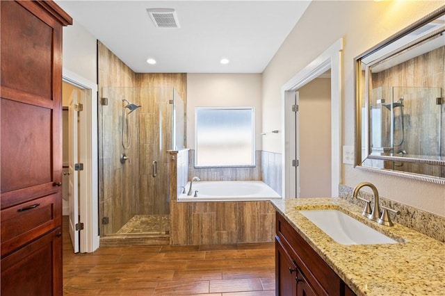 2342 Vaughan Dr, Corpus Christi, TX 78414 - full bathroom featuring a shower stall, vanity, a garden tub, wood finished floors, and recessed lighting