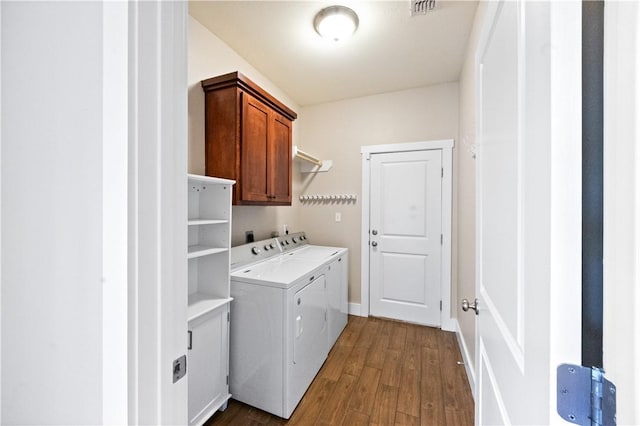 2342 Vaughan Dr, Corpus Christi, TX 78414 - washroom with separate washer and dryer, cabinet space, and dark wood finished floors