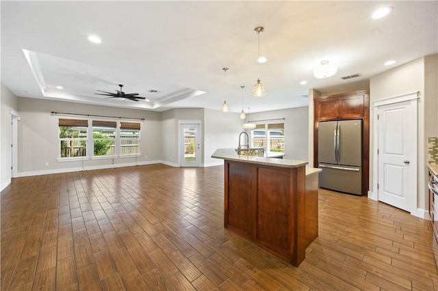 2342 Vaughan Dr, Corpus Christi, TX 78414 - kitchen with freestanding refrigerator, light countertops, recessed lighting, dark wood-style flooring, and a raised ceiling