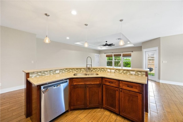 2342 Vaughan Dr, Corpus Christi, TX 78414 - kitchen with stainless steel dishwasher, a raised ceiling, ceiling fan, light wood-style flooring, and hanging light fixtures