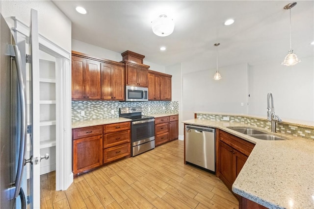 2342 Vaughan Dr, Corpus Christi, TX 78414 - kitchen featuring stainless steel appliances, tasteful backsplash, pendant lighting, and light wood-style flooring