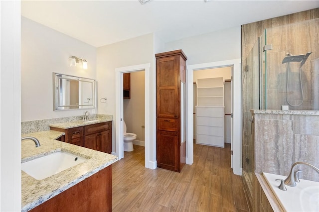 2342 Vaughan Dr, Corpus Christi, TX 78414 - full bath with a shower stall, two vanities, wood finished floors, and tiled bath