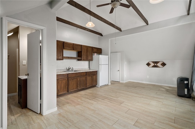 kitchen featuring sink, ceiling fan, beam ceiling, decorative light fixtures, and white fridge