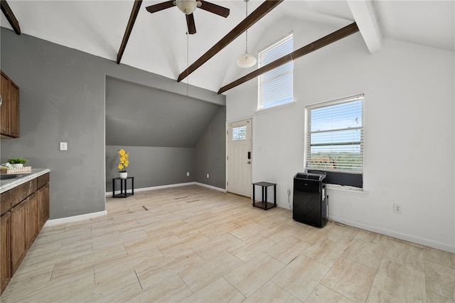 living room featuring ceiling fan, beam ceiling, sink, and high vaulted ceiling