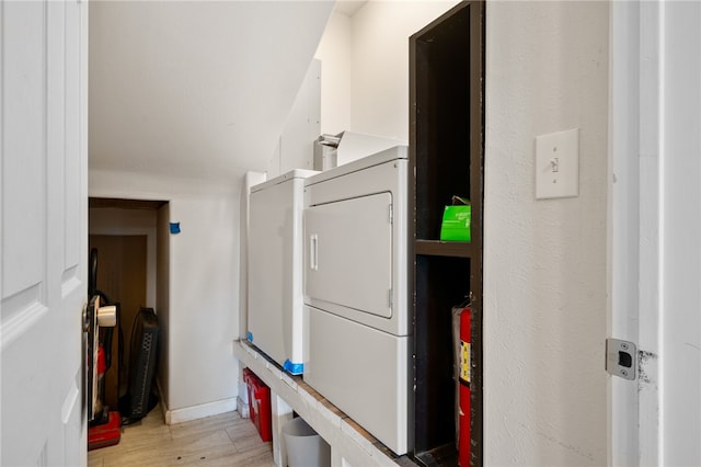 laundry area featuring light hardwood / wood-style floors and washer / dryer