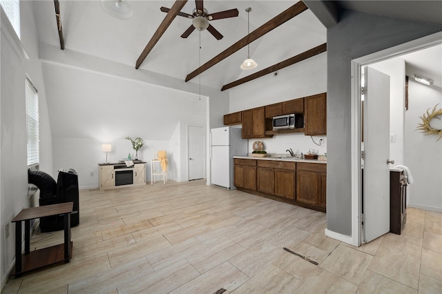 kitchen with high vaulted ceiling, beam ceiling, sink, and white fridge