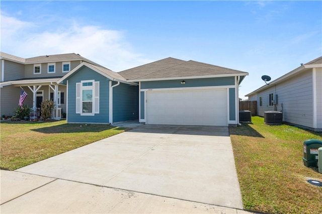 view of front facade with a garage, driveway, a front lawn, and central AC