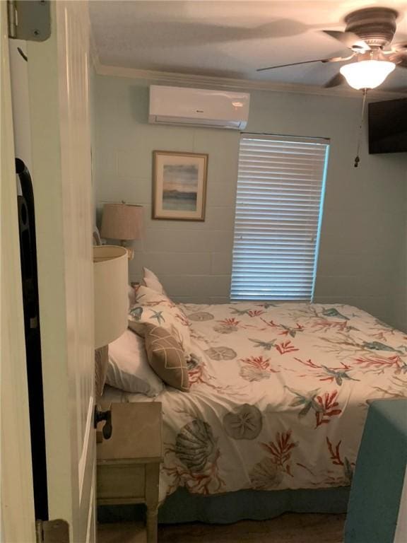 bedroom with ceiling fan, a wall mounted AC, and ornamental molding