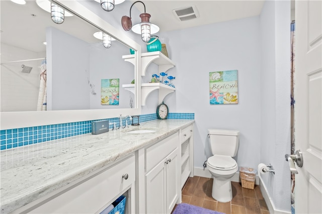 bathroom with vanity, toilet, and a shower with shower curtain