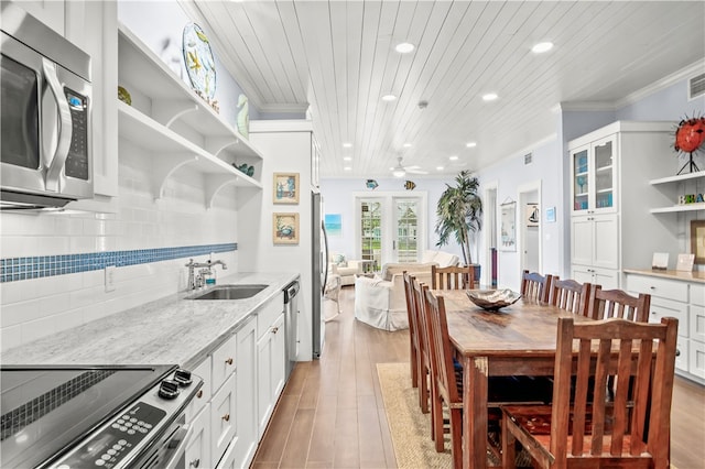 kitchen with light stone counters, stainless steel appliances, wooden ceiling, and white cabinets