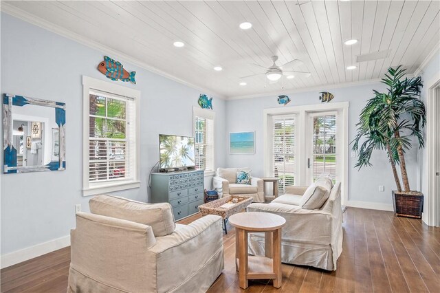 living area featuring hardwood / wood-style floors, ornamental molding, and a healthy amount of sunlight