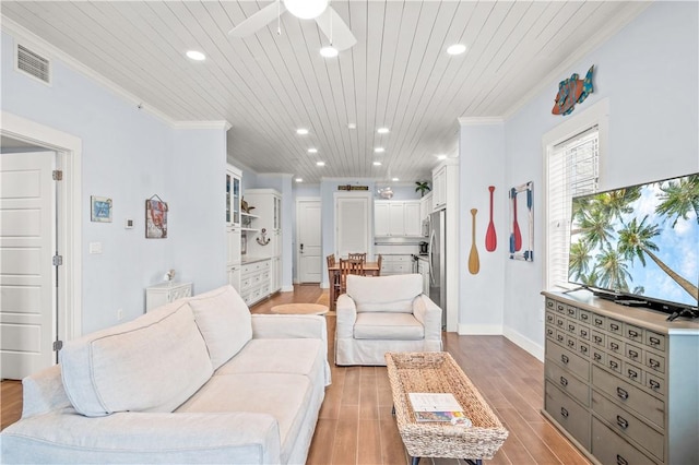 living room featuring ceiling fan, ornamental molding, light hardwood / wood-style flooring, and wooden ceiling