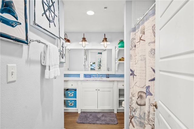 bathroom featuring a shower with curtain, wood-type flooring, toilet, and vanity