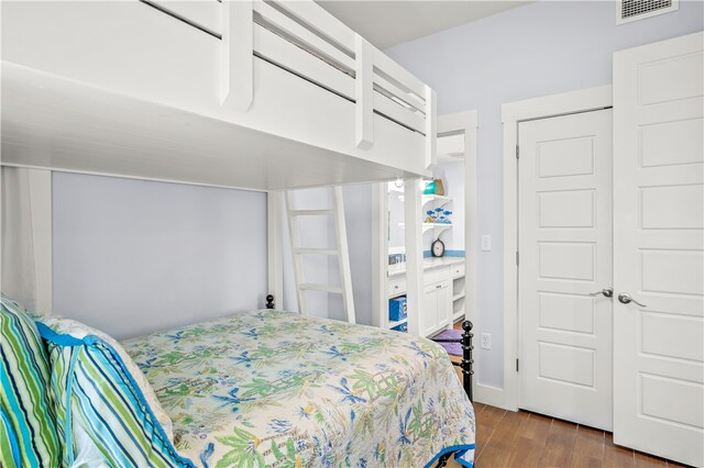 bedroom with hardwood / wood-style flooring