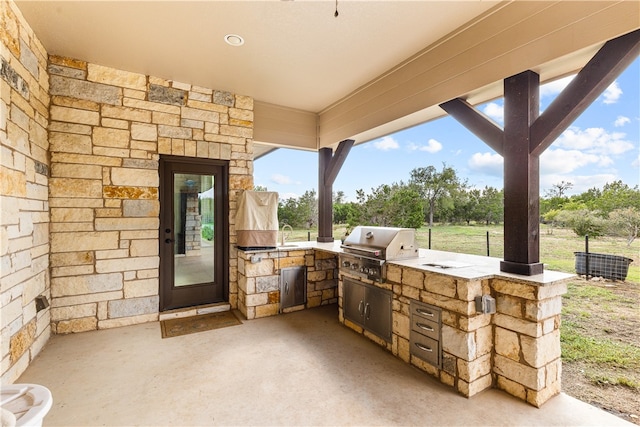 view of patio / terrace with an outdoor kitchen and a grill