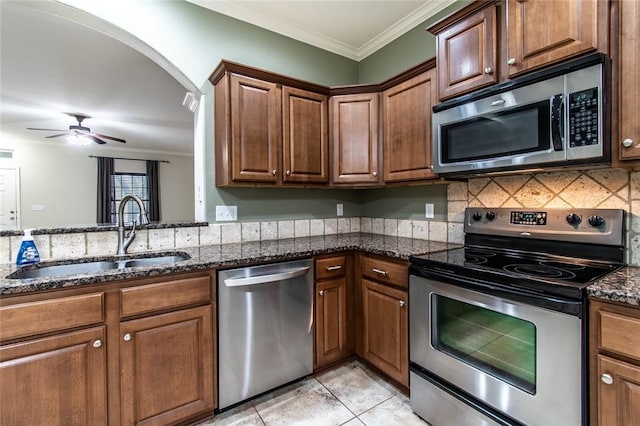 2526 Whirlwind St, Corpus Christi, TX 78414 - kitchen with appliances with stainless steel finishes, crown molding, ceiling fan, dark stone countertops, and backsplash