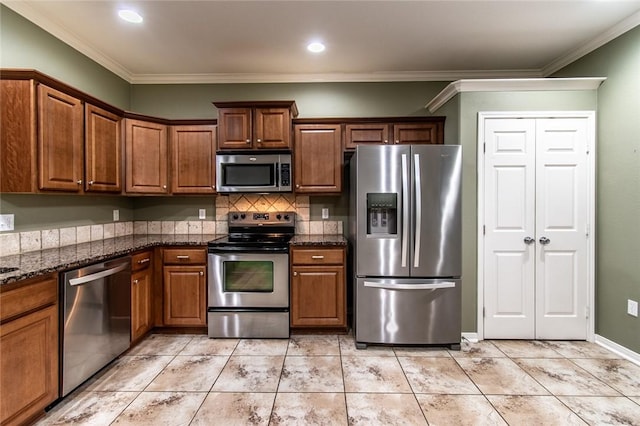 2526 Whirlwind St, Corpus Christi, TX 78414 - kitchen with stainless steel appliances, crown molding, tasteful backsplash, dark stone countertops, and brown cabinets