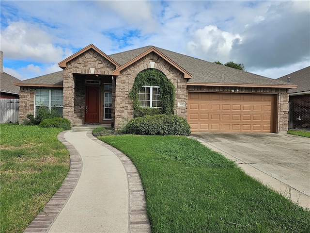 view of front facade with a front lawn and a garage