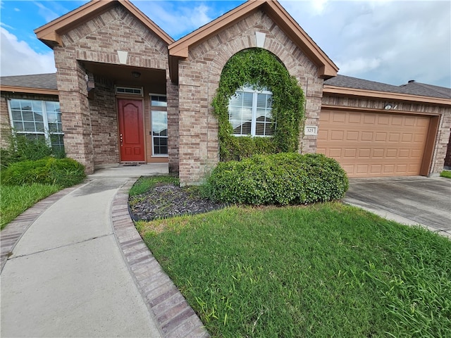 view of front of property with a front lawn and a garage