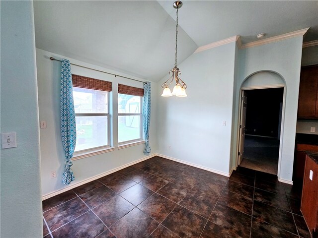 unfurnished dining area featuring dark tile patterned flooring, a chandelier, vaulted ceiling, and ornamental molding