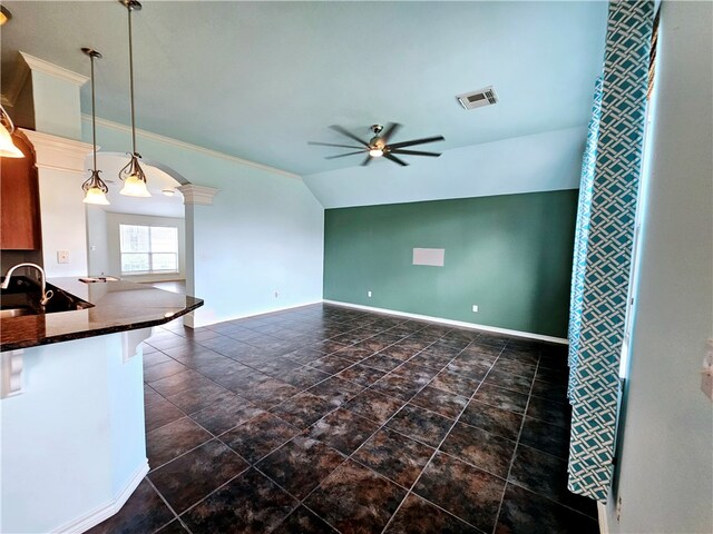 kitchen featuring vaulted ceiling, sink, decorative columns, ceiling fan, and decorative light fixtures