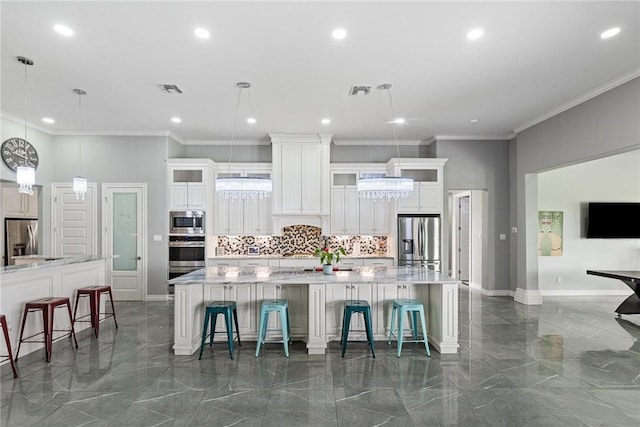 6406 Legacy Pt, Corpus Christi, TX 78414 - kitchen featuring stainless steel appliances, a large island, decorative backsplash, and marble finish floor