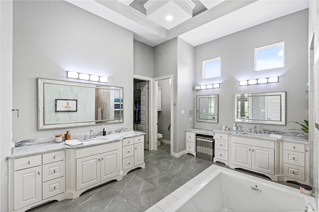 6406 Legacy Pt, Corpus Christi, TX 78414 - bathroom featuring a tub to relax in, a sink, a high ceiling, and toilet