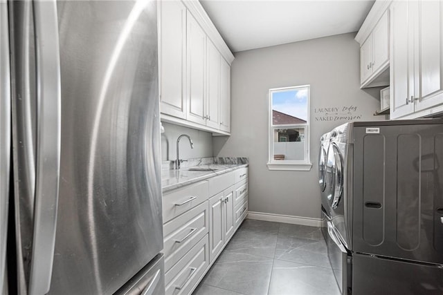 6406 Legacy Pt, Corpus Christi, TX 78414 - washroom featuring washing machine and dryer, cabinet space, a sink, baseboards, and marble finish floor