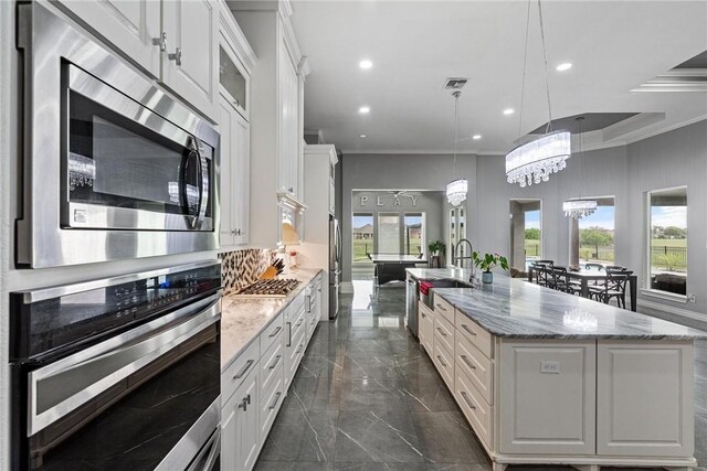 6406 Legacy Pt, Corpus Christi, TX 78414 - kitchen with appliances with stainless steel finishes, a sink, marble finish floor, white cabinetry, and visible vents