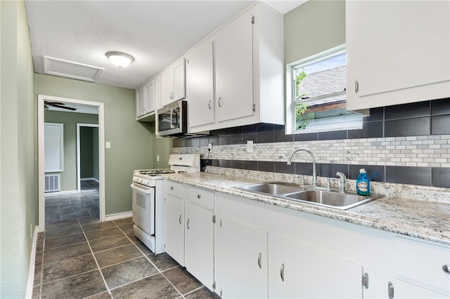 kitchen with white cabinetry, backsplash, a textured ceiling, sink, and white gas stove