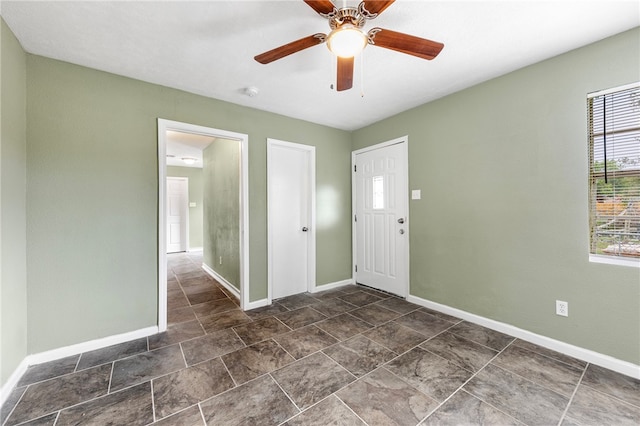 foyer entrance featuring ceiling fan