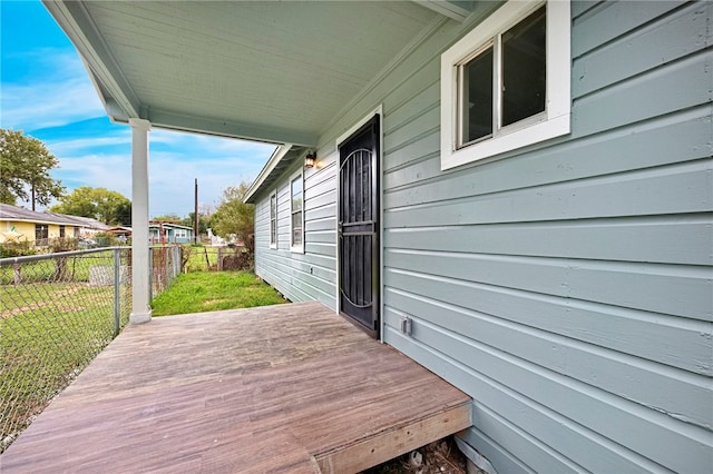 wooden terrace with a lawn