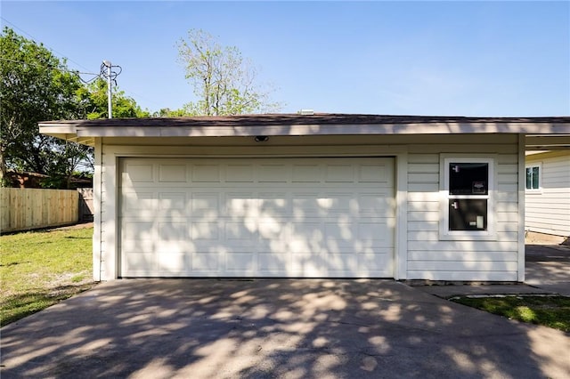 detached garage featuring fence