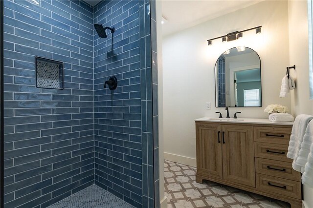 530 Indiana Ave, Corpus Christi, TX 78404 - bathroom with a tile shower, vanity, and baseboards