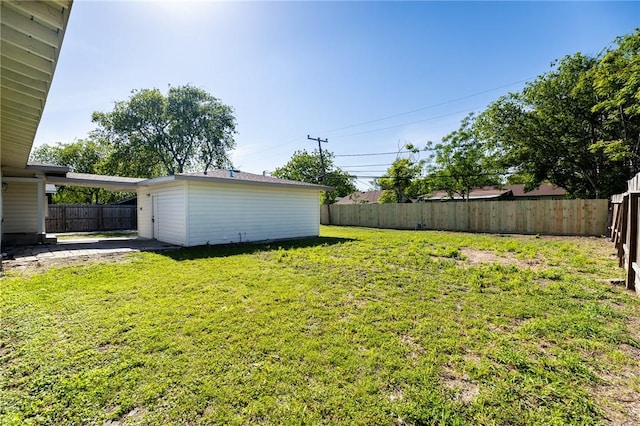 view of yard featuring an outbuilding and a fenced backyard