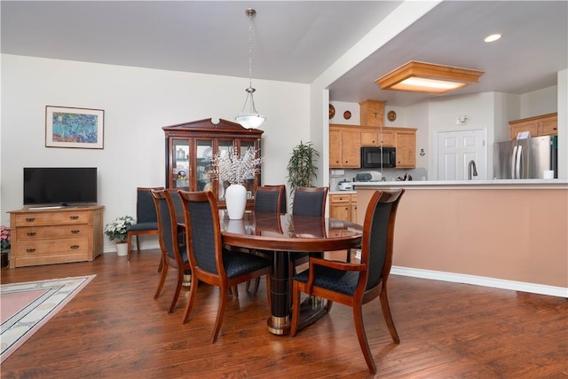 dining space featuring dark hardwood / wood-style flooring