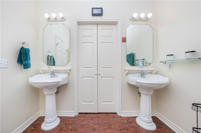 bathroom featuring double sink and wood-type flooring