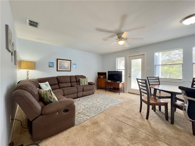 living room with light colored carpet and ceiling fan